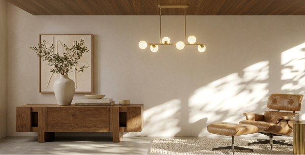 A modern living room interior with warm wood furniture, a brown leather lounge chair and ottoman, a brass pendant light, and soft sunlight casting shadows across the wall.