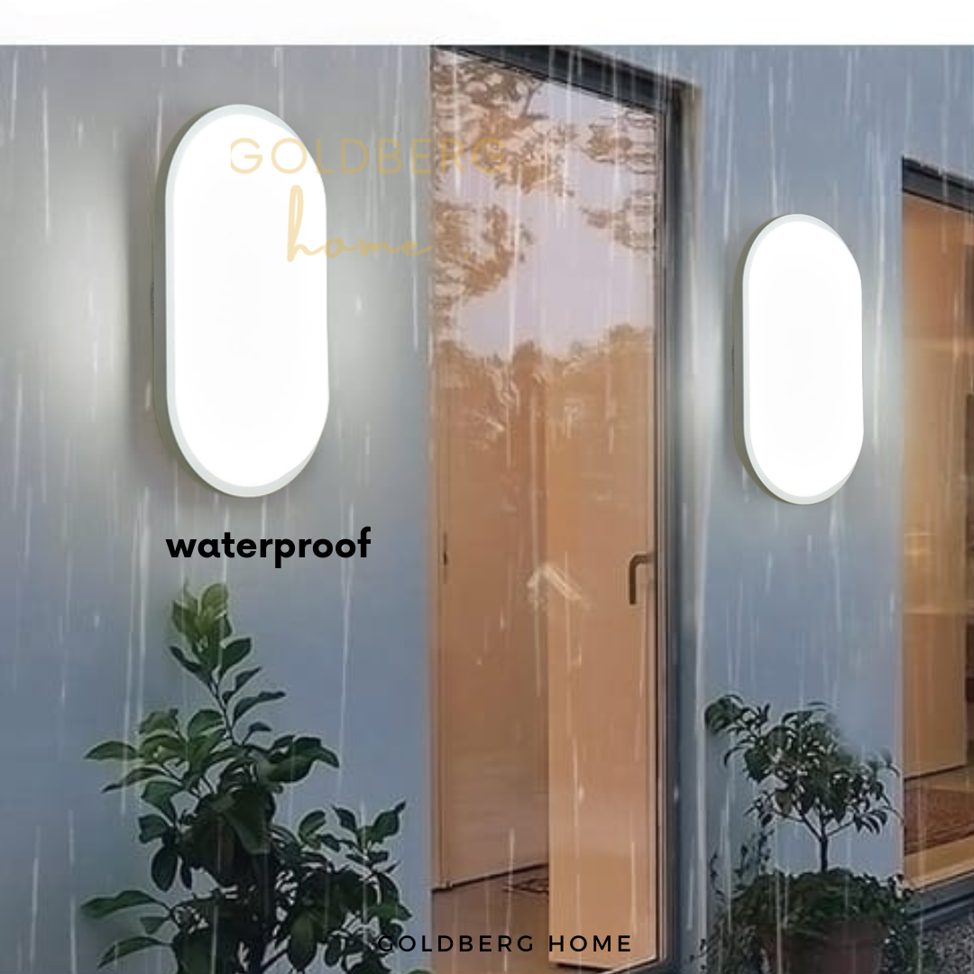 Modern black Brantford wall lamp lighting up a Singapore patio garden by Goldberg Home.