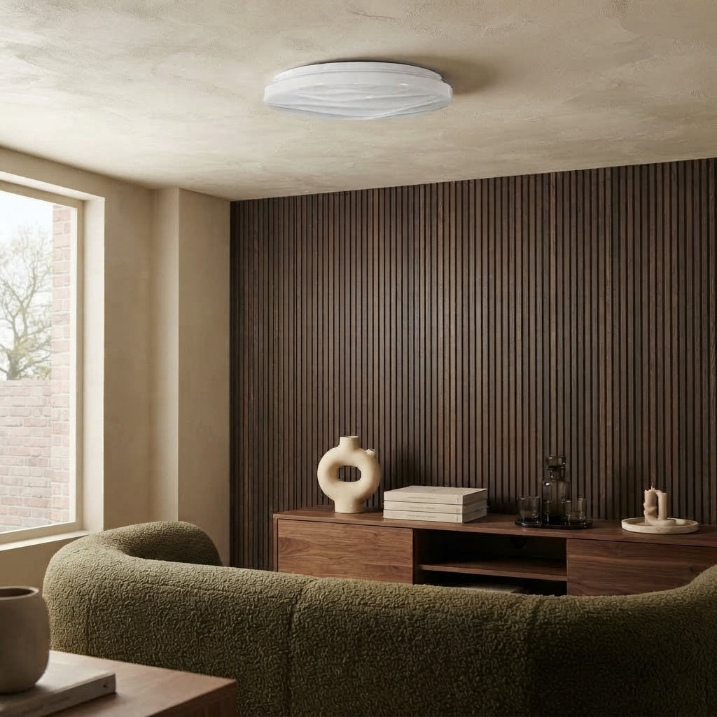 Goldberg Home Leeds Twist & Turn white LED ceiling light installed in modern living room interior with dark wood slatted accent wall.