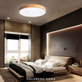 Goldberg 30cm wood ceiling light providing warm white ambiance in a minimalist Singapore condo bedroom.